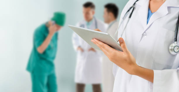 istock Doctor working in hospital with other doctors. 1059409556