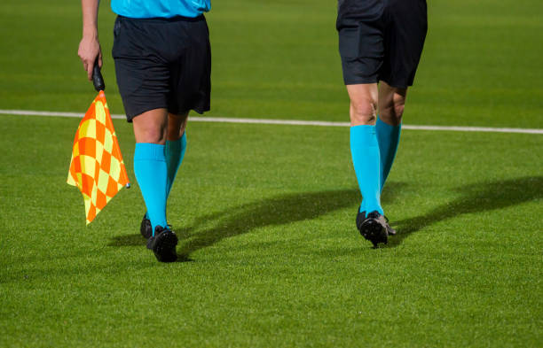 istock Low Section Of Referees Walking On Soccer Field 1059410146