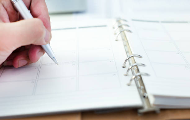 istock Cropped Hand Writing On Calendar 1059417002