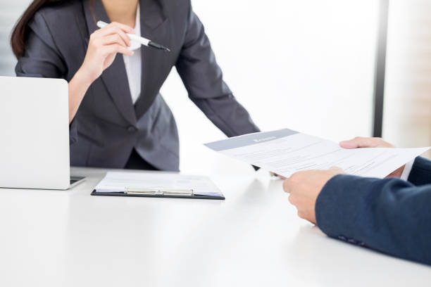 istock Colleagues Doing Paperwork At Desk In Office 1059421690