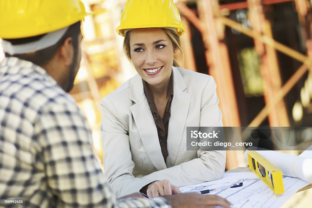 construction worker and female architect latin american construction worker and female architect talking. Copy space Construction Site Stock Photo