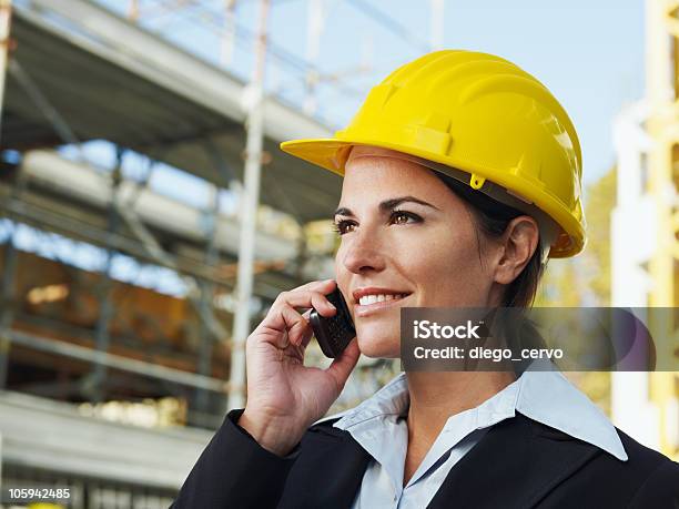 Young Female Engineer In A Hard Hat On The Phone Stock Photo - Download Image Now - Business, Women, 30-34 Years