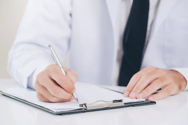 istock Doctor in hospital writing on a paper document. 1059425740