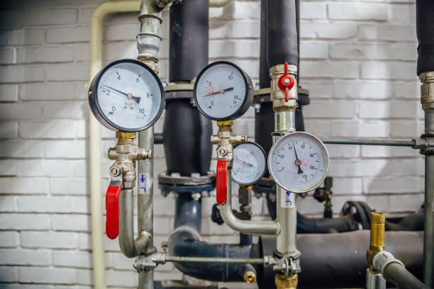 Steel pipeline of heating system with manometers Steel pipeline of heating system with manometers. gauge pressure gauge pipe valve stock pictures, royalty-free photos & images