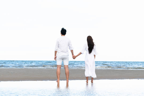 istock Couple going honeymoon on tropical beach in summer 1059426352