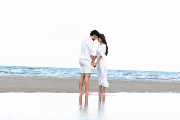 istock Couple going honeymoon on tropical beach in summer 1059426404