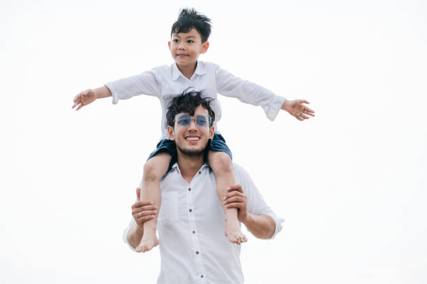 istock Happy father carrying his son on the neck. 1059428092