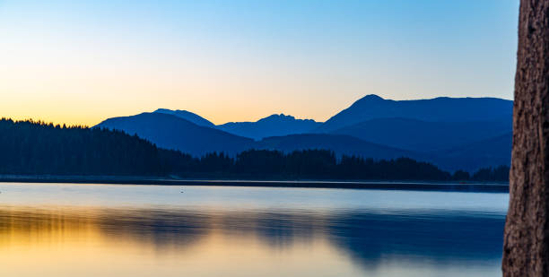 The yellow and blue sunset at Lois Lake stock photo