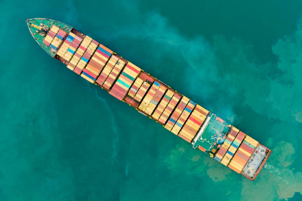 istock Fresh colorful Container cargo ship, Business International trade and Container logistics export-import harbor to the International port / Shipping Containers concept. - Bird's-eye view from drone. 1059430616