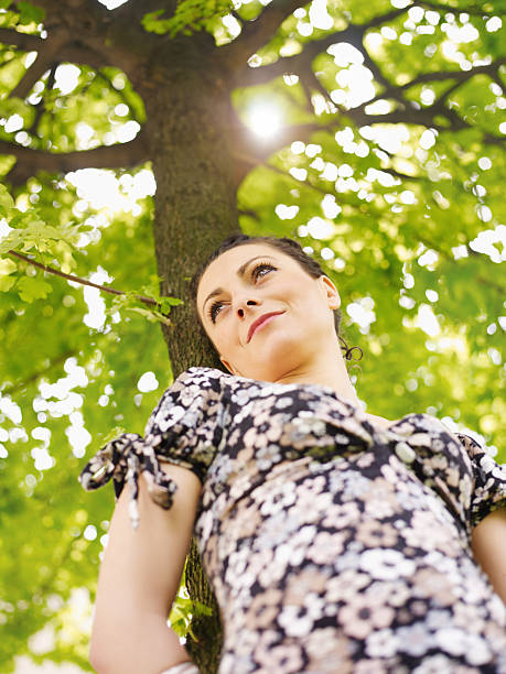 istock young woman in park, smiling 105943075