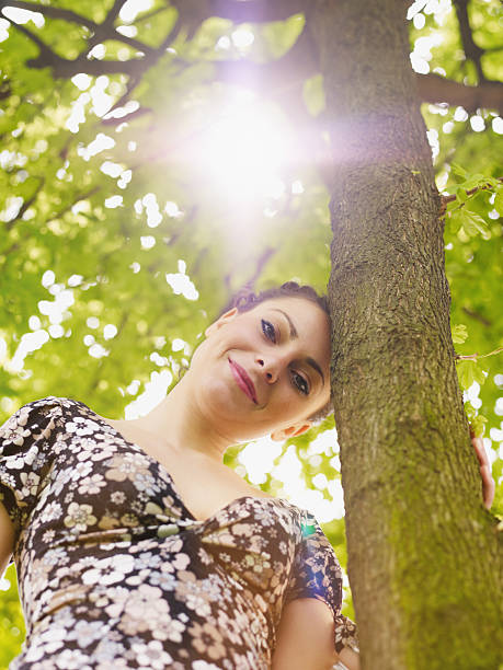 istock young woman in park, smiling 105943084