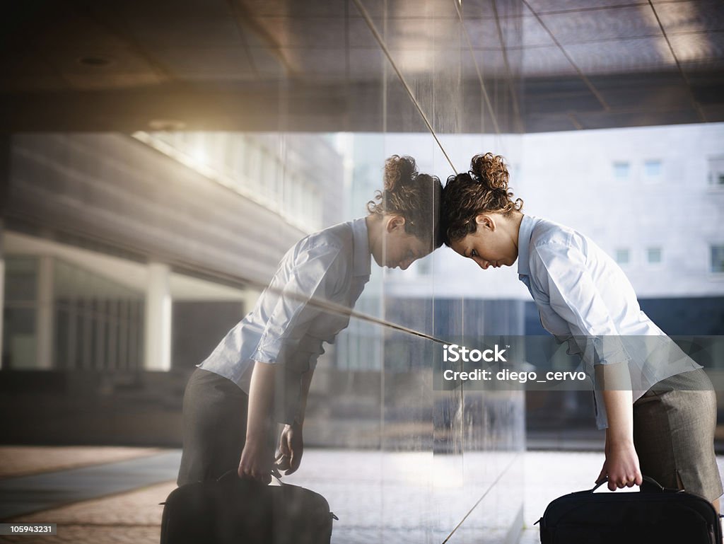 sad businesswoman mid adult italian woman banging her head against a wall outside office building. Horizontal shape, copy space Working Stock Photo