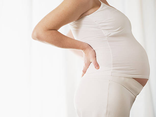 istock Pregnant woman holding her back 105943368