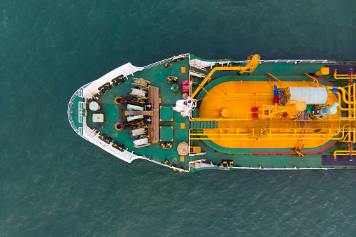 Sea freight, Crude oil tanker lpg ngv at industrial estate Thailand / oil tanker ship to port of Singapore - import export around in the world. Aerial Top View