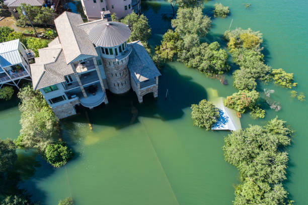 climate change  Mansions and luxury homes flooded Top-Down drone natural disaster flooded mansions Mansions and luxury homes flooded aerial drone view above Texas hill country completely destroyed by historic flood waters natural disaster photos stock pictures, royalty-free photos & images
