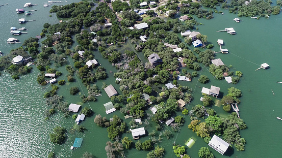 Drone view above neighborhood Flooded after Major flood aerial view looking down above homes and houses under water .