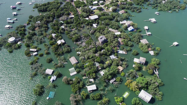 Drone view above neighborhood Flooded after Major flood Drone view above neighborhood Flooded after Major flood aerial view looking down above homes and houses under water . flood plain photos stock pictures, royalty-free photos & images