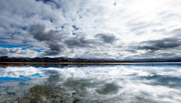 istock Reflections on a cloudy day on a still lake 1059446436