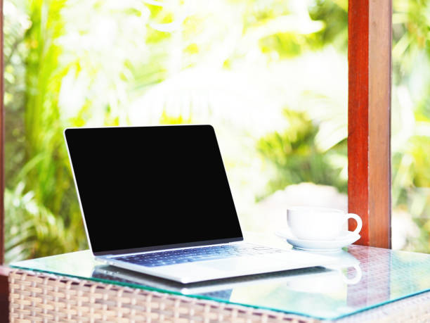 istock White cup of coffee and blank screen laptop 1059454400