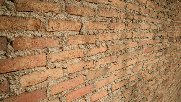 istock Side view of old orange vintage brick wall 1059454598