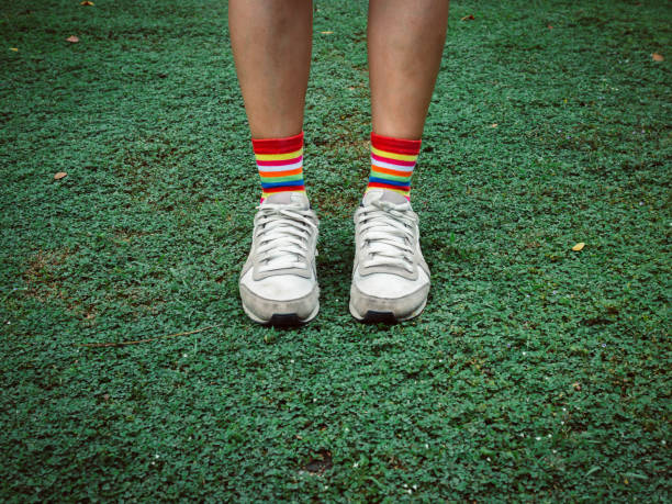 istock Colorful stylish socks on green field 1059454754