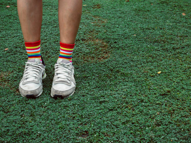 istock Colorful stylish socks on green field 1059454848