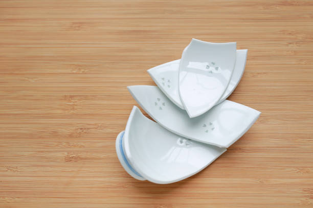 istock Pieces of broken ceramic Bowl on wood background. 1059461522