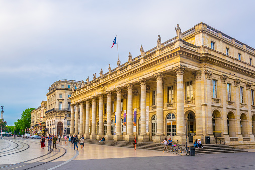 Frankfurt, Germany - April, 20. 2022: Old opera house in Frankfurt in Germany. Some pedestrians are around.