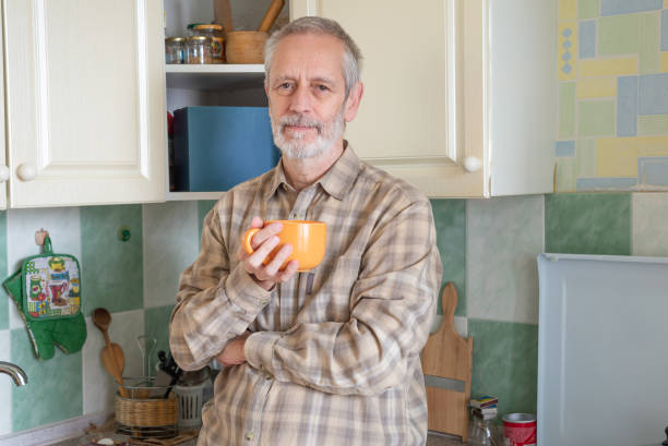 istock Mature man drinking his coffee in kitchen 1059480454