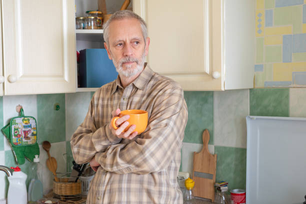 istock Mature man drinking his coffee in kitchen 1059481514