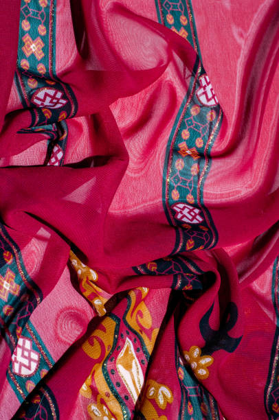 istock Background texture, pattern. Red maroon fabric. Click on your local heritage with this red, bard and yellow striped silk. This patterned fabric will decorate your design. your work will be exclusive 1059482254