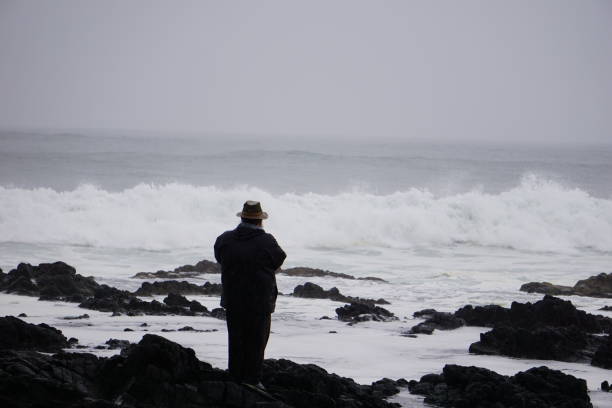 Lava, man, water, waves, back facing camera Oregon Coastline