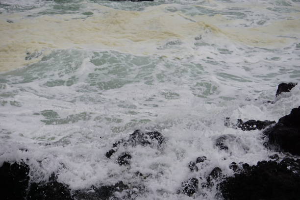 istock Rocky lava covered in violent water 1059488384