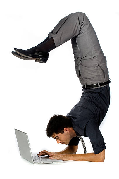 istock Athletic businessman using laptop in awkward position 105949514