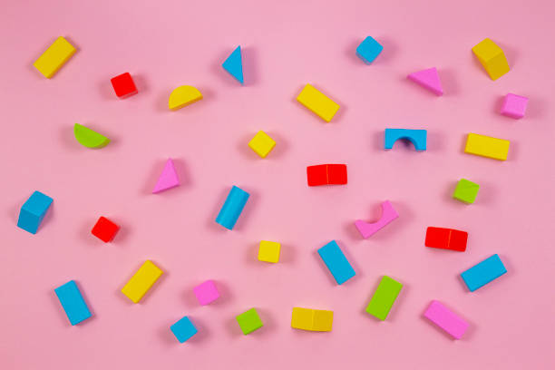 istock Colorful wooden building blocks on pink background 1059499564