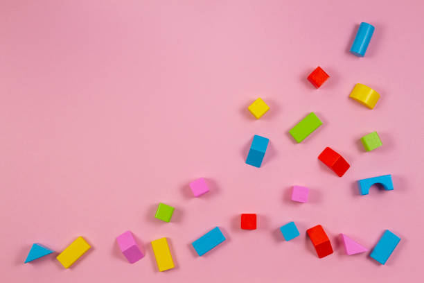 istock Colorful wooden building blocks on pink background 1059499628