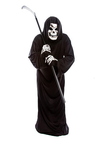 Costume of a skeleton grim reaper wielding a scary scythe.  The undead ghost is wearing a black robe to represent October Halloween holiday.  Isolated on a white background