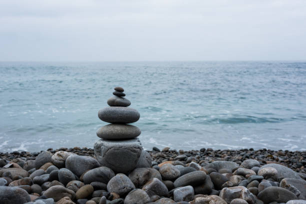 istock Stack of stones on beach, sea and sky 1059501096