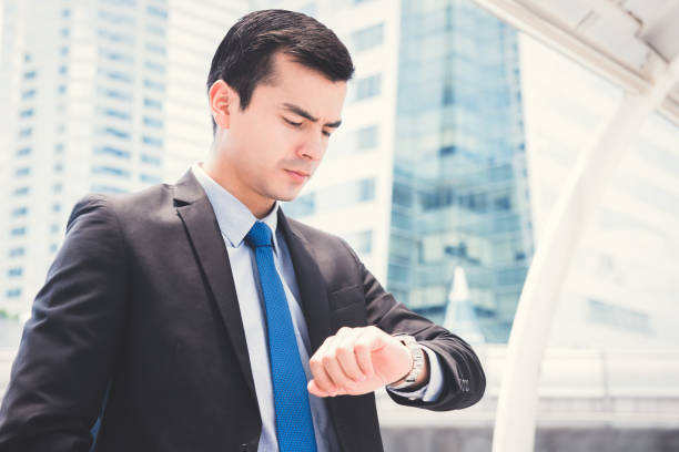 istock Businessman looking at his watch checking time 1059501916