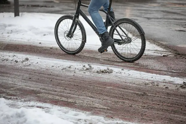 male cyclist on snowy bike lane