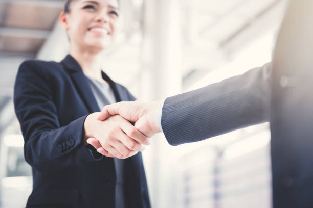 istock Businesswoman making handshake with a businessman 1059510530