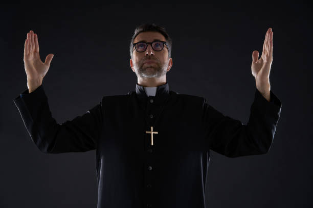 istock Priest open arms blessing praying God 1059515934