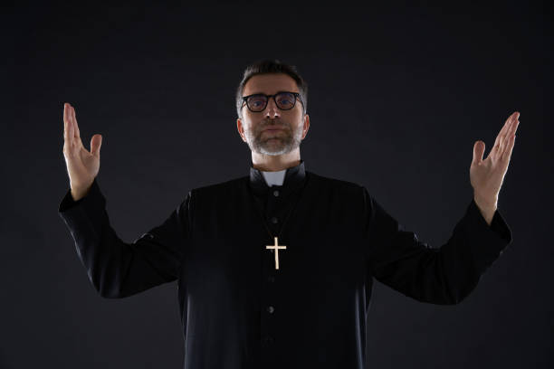 istock Priest open arms blessing praying God 1059516110