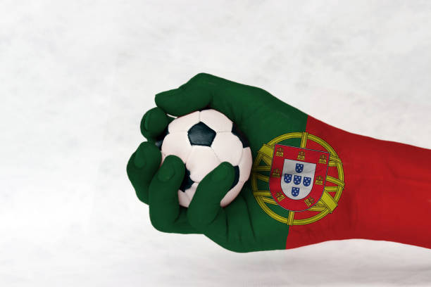 Mini ball of football in Portugal flag painted hand on white background. stock photo