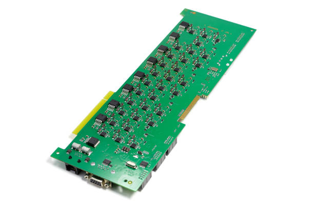 Electronic printed circuit board with chips and other components, green color, back side, angled view, isolated on white background