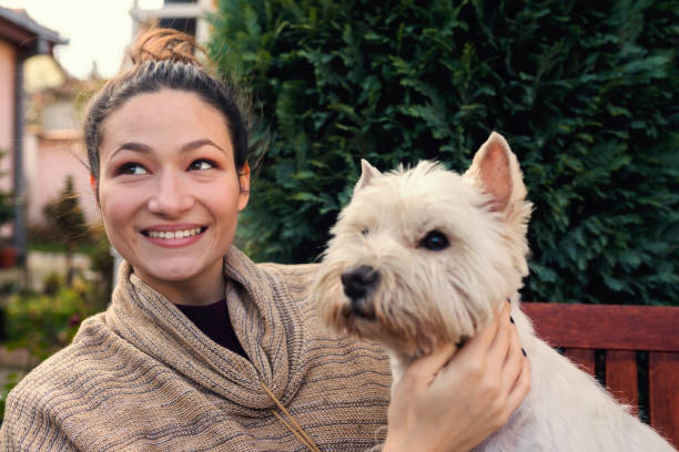 istock Cheerful young woman with cute dog 1059527340