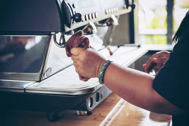 istock Barista cleaning coffee machine at coffee shop 1059533488