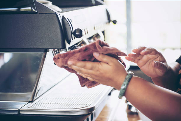 istock Barista cleaning coffee machine at coffee shop 1059533536