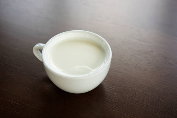 istock A white cup of milk on wooden 1059533598
