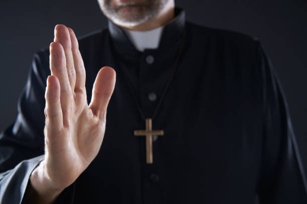 Pirest hand blessing closeup with cross Priest hand blessing closeup with cross and clergyman background priest photos stock pictures, royalty-free photos & images